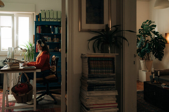 Female Remote Worker at Desk in Warm Home Interior