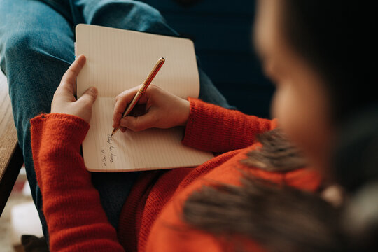 Close Up of Woman Writing Notes in Notebook