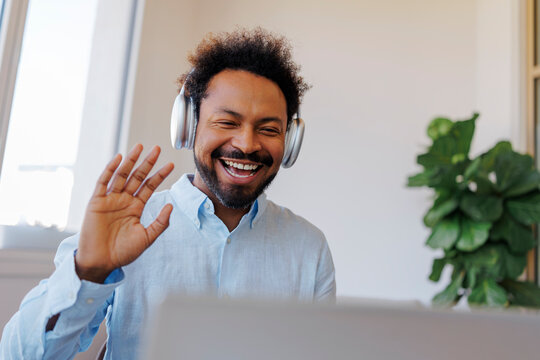 Afro hairstyle man waving smiling during remote video call