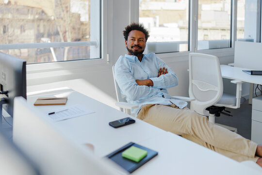 Man relaxing brainstorming creative ideas in modern office