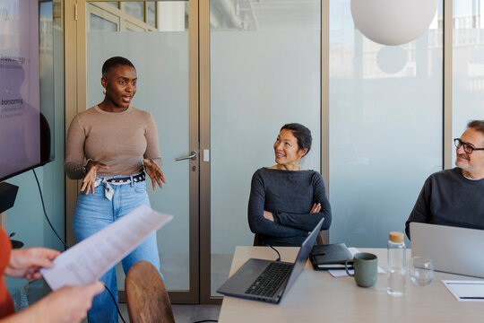 Female presenter sharing ideas during business team meeting