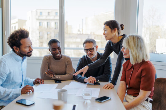Business professionals discussing project during meeting at office