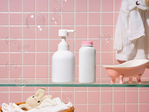 Baby bath time essentials with bubbles and cute bunny toy on a shelf