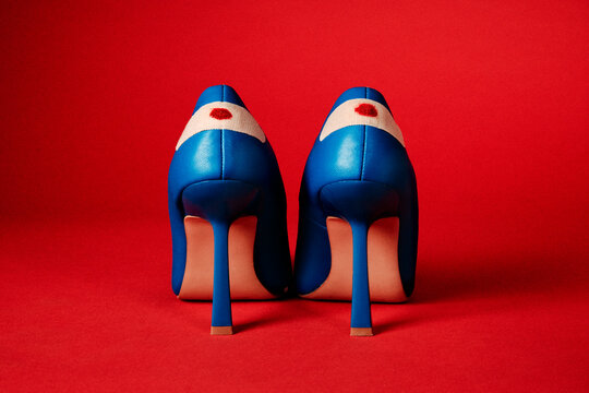 heels with blood stained bandages on a red background