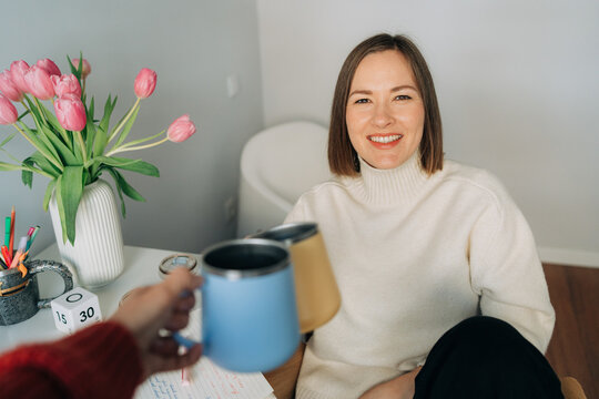 Friends Toasting Coffee Mugs in Home Office