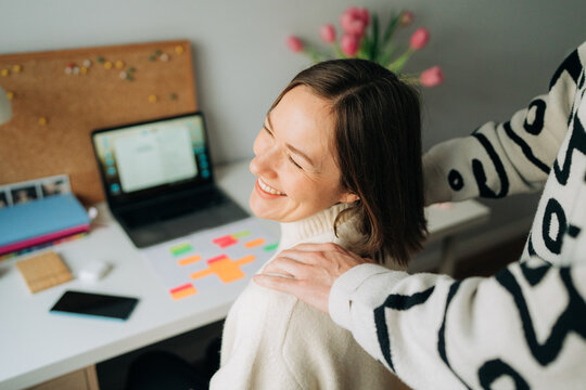 Woman Smiling While Partner Massages Her Neck