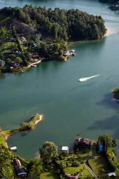 Speedboat Crossing Emerald Water Of Guatape Reservoir