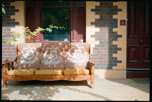 Sofa on Porch in Front of Brick Fitzroy House