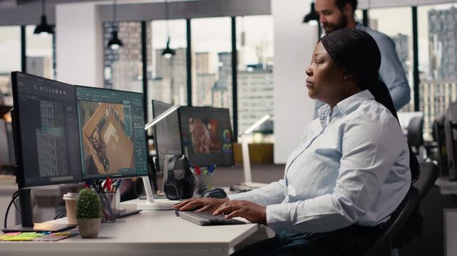 African american architectural developer using 3D designing interface, woman architect working on redesigning new apartment floor plan with virtual assets. Professional computer graphics.