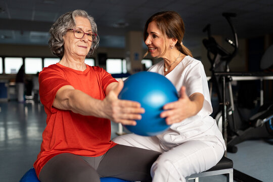 Senior woman doing physiotherapy with therapist