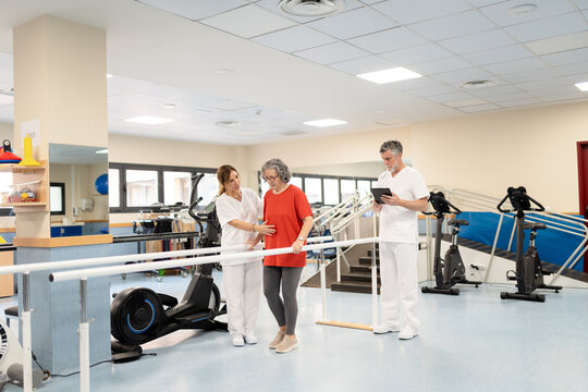 Physiotherapist assisting senior woman during walking rehabilitation