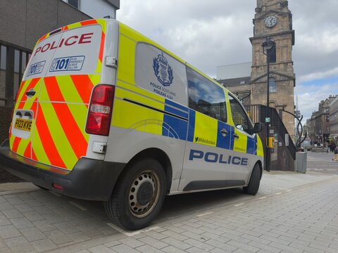 Police Scotland prisoner van parked in Inverness in the Highlands of Scotland. Showing the reflective yellow and blue battenberg markings on the side of the vehicle. 