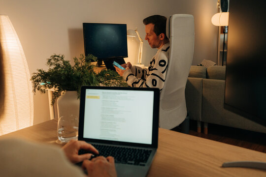 Couple Working Separately in Home Office