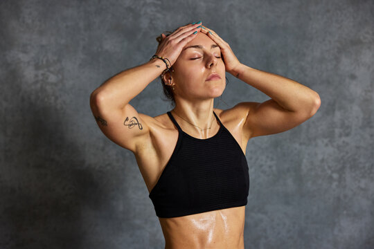 Woman works out and feels the strain in a gym setting