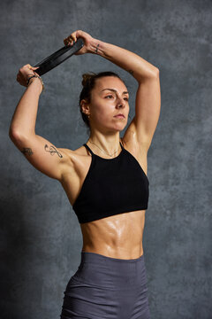 Woman exercising with a resistance band in fitness training sess