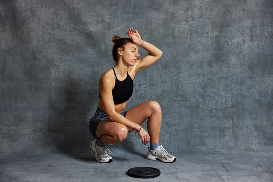 Woman exercises with weights in a gym during a workout session