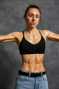 Fitness model showing results of hard work in a studio