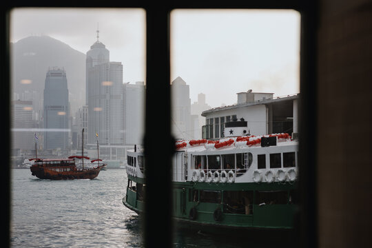 Hong Kong Ferry and Traditional Boat on Victoria Harbour