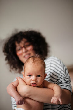 Mother Holding Newborn Baby In Loving Embrace