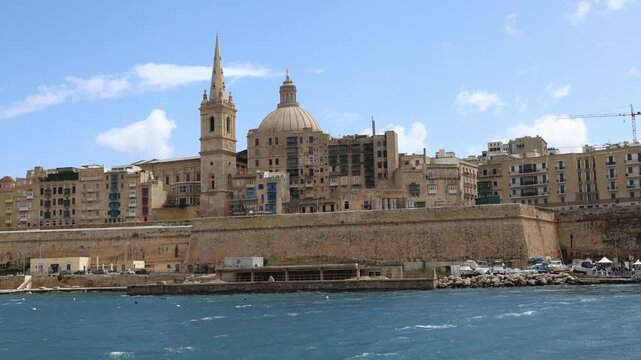 Valletta Skyline With Our Lady of Mount Carmel Church Dome and Steeple Seen From Sea on Sunny Day Malta