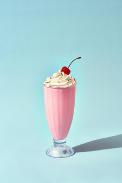 Strawberry milkshake with cream and cherry