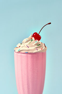 Strawberry milkshake with cream and cherry