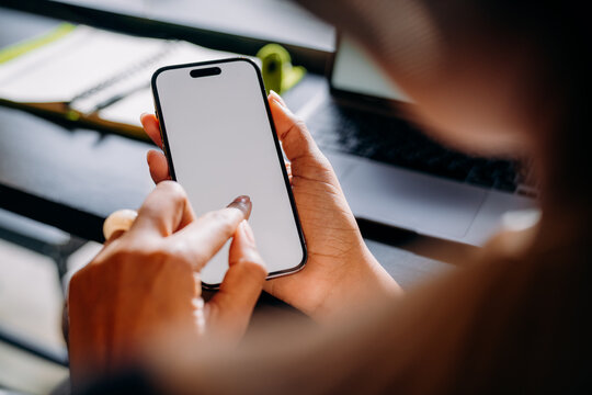 A woman using a mobile phone with a white screen
