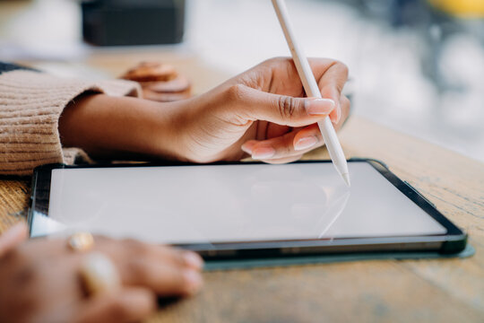 A woman using a tablet in a cafe