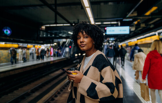 A woman using a mobile phone in the subway