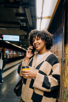 A woman talking on a mobile phone in the subway