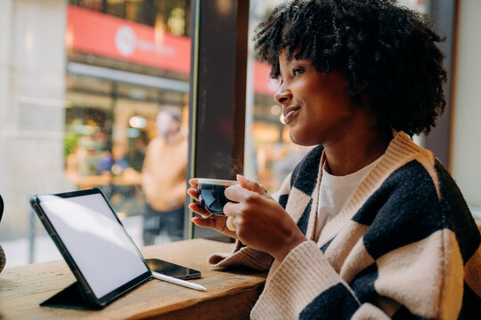 A woman using a tablet in a cafe