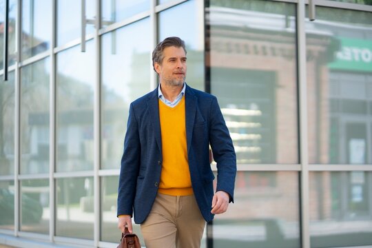 Businessman Walking Outside Modern Office Building