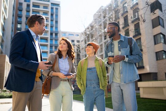 Group of friends talking in a city building area