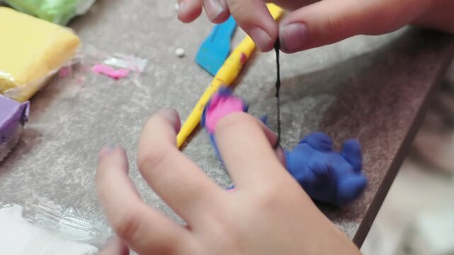 Little girls sculpt figurines crafts from air plasticine, modeling dough. Online lessons in tablet. Children's creativity hobby developing activities, training, learn of fine motor skills of hands.
