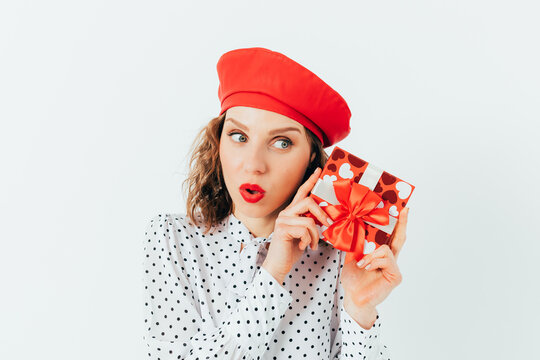 Girl holds red gift wrapped with bow
