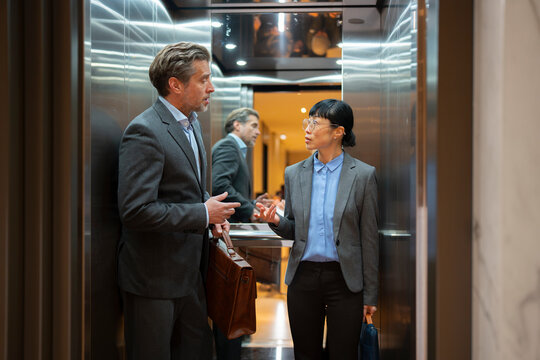 Office elevator chat with coworkers