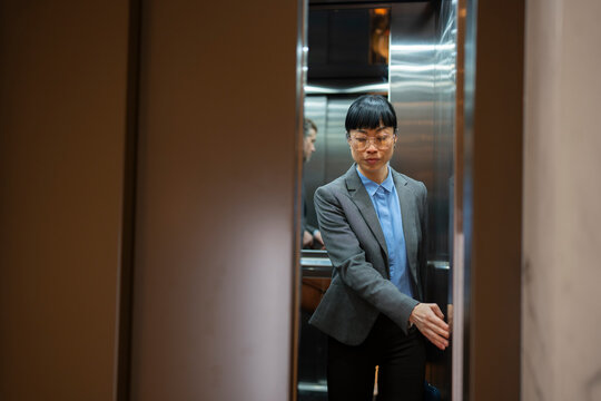 Person exits elevator in office building setting