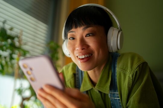 Happy woman listens to music on phone