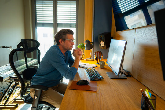 Man at desk working on computer in home office