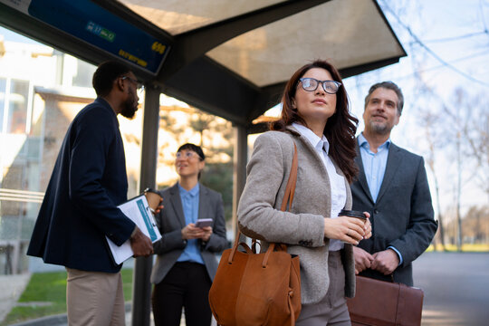 Business people waiting at a bus stop in the city
