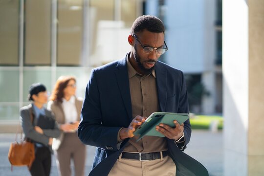Businessman using tablet in city office setting