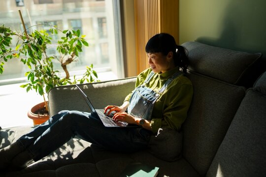 Hybrid professional taking call while working from home