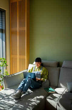 Woman working on laptop in a modern living room