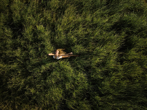 Top Down View Woman in White Dress Dancing in Grass  Field