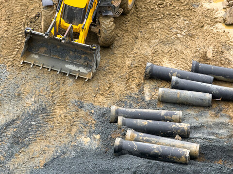 Construction Machinery and Infrastructure Pipes Waiting to be Laid