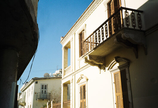 Buildings and Balconies in a Historic Street Under Bright Blue Sky