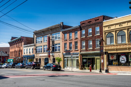 Middletown, NY - US - Apr 18, 2026 West Main Street in Middletown showcases historic brick buildings, local storefronts, and parked cars under a clear sky, reflecting a classic American downtown feel