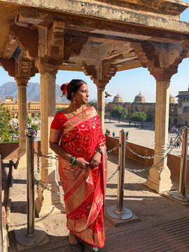 Woman in Traditional Dress Stands at a Historical Site in India