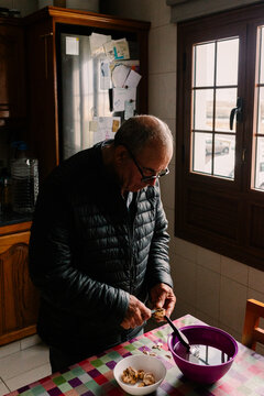 Elderly man rinsing and trimming desert truffles