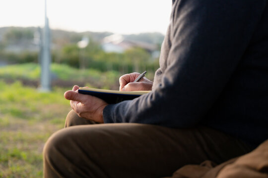 Man Writing With Focus Outside